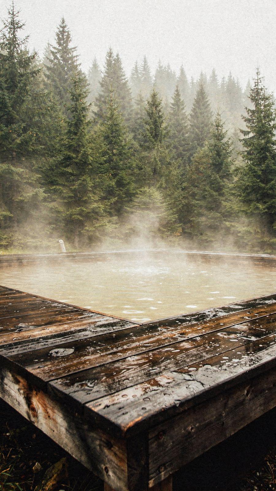 Mineral bathing pool on a timber deck in the Skole Beskids, steam rising in cold morning air